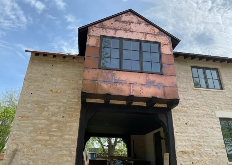 Copper metal panel facade on a stone building for Roof Repair in Fort Collins