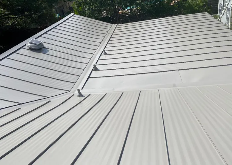 Solar attic fan installed on a metal roof for Roof Ventilation in Fort Collins